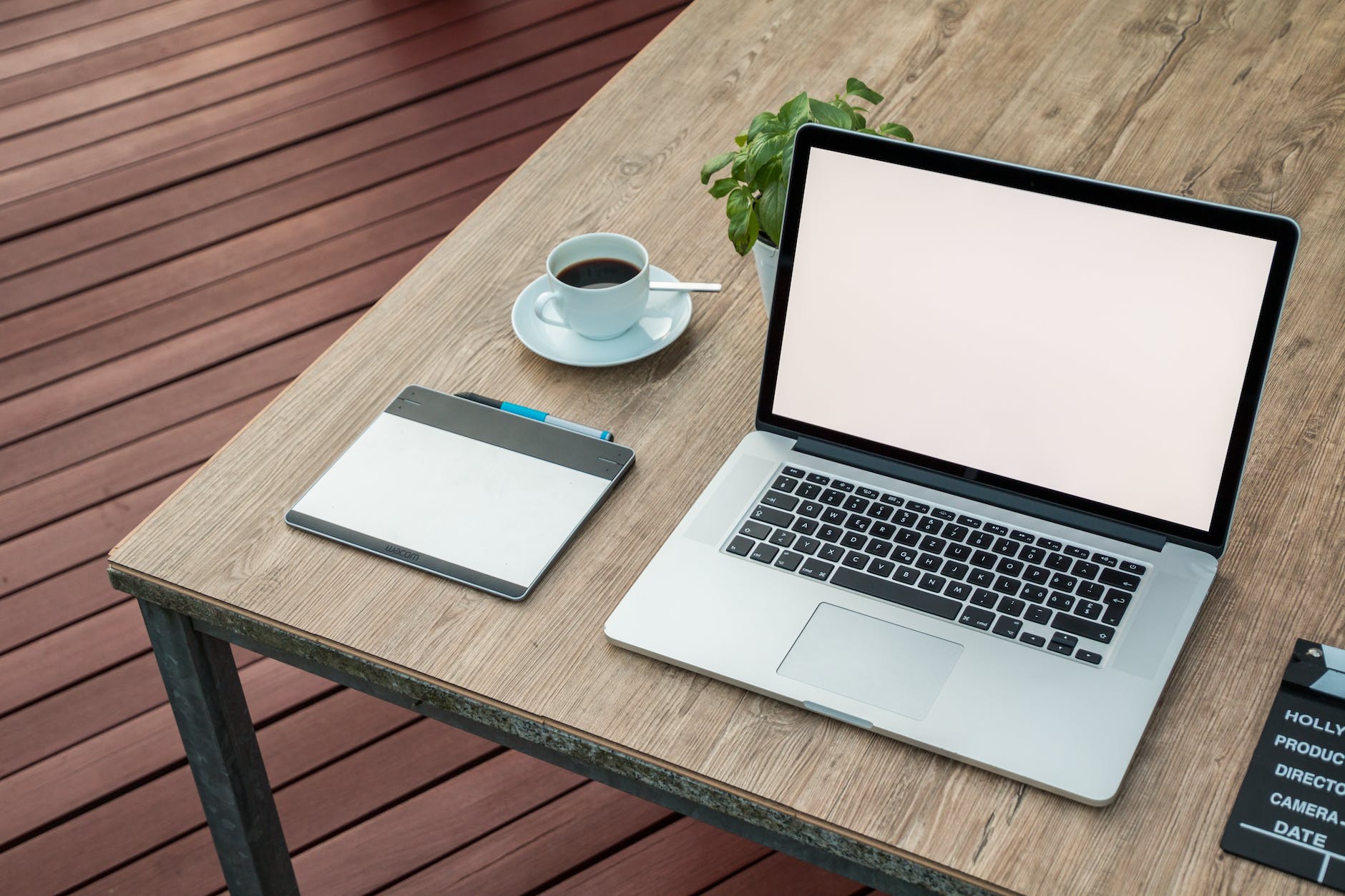Photo of laptop on table with coffee cup
